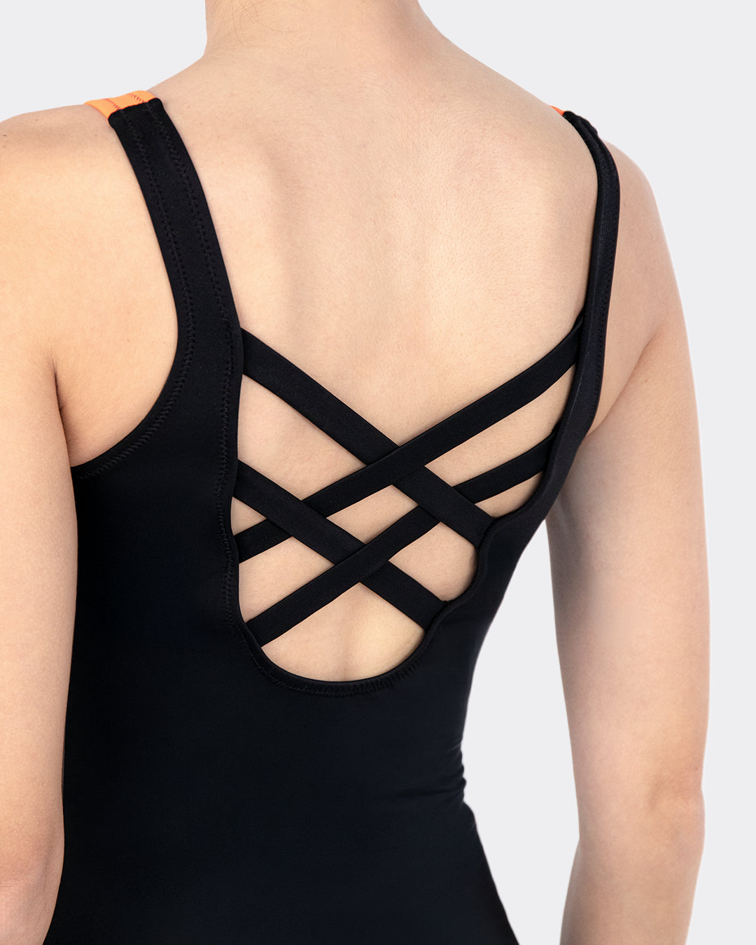 Nahaufnahme Rückendetail MYLILY Perioden-Badeanzug: schwarze Kreuzträger mit dekorativem Strappy-Cut-Out – markantes Rückendesign des sportlichen Perioden-Einteilers in Schwarz/Orange